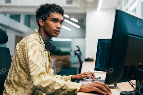 Preview: young programmers working on a new project for a start up business.