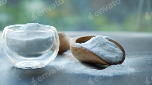 Preview: Glass bowl of baking soda. Spoonful of bicarbonate.