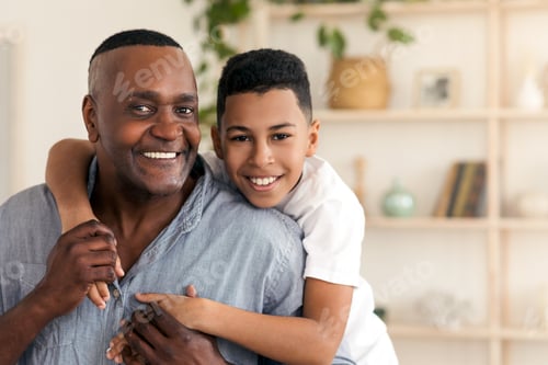 Preview: Family Bonding. Portrait Of Happy Black Preteen Boy Embracing His Grandfather