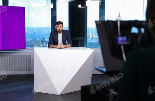 Preview: Presenter and video camera operator working in studio. News broadcasting