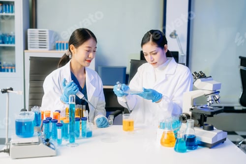Preview: Two Asian female scientists in a high-tech lab analyzing biochemical