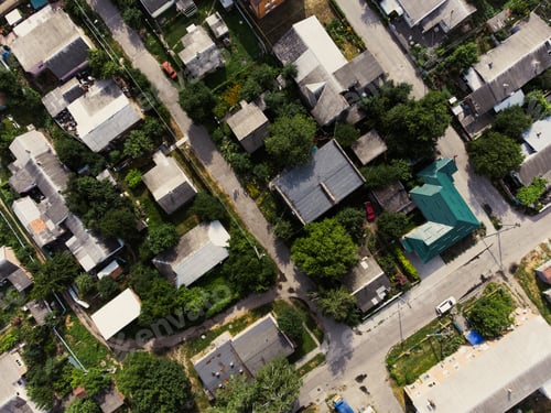 Preview: Aerial view of suburb of European city. Green neighbourhood on a sunny summer day. County living