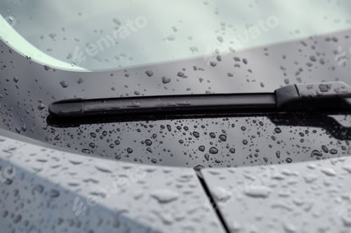 Preview: Car wiper and water drops on windshield glass, closeup