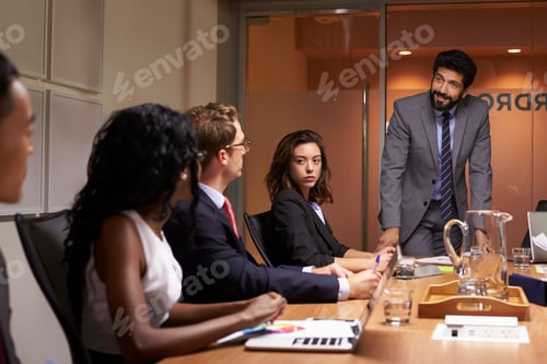 Preview: Businessman addressing colleagues at a meeting, close up
