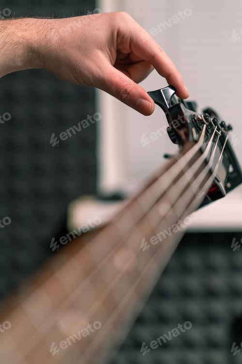 Preview: rock performer with electric guitar recording playing own track tuning musical instrument strings