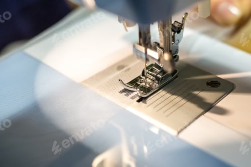 Preview: close up mechanism of sewing machine foot with needle and thread