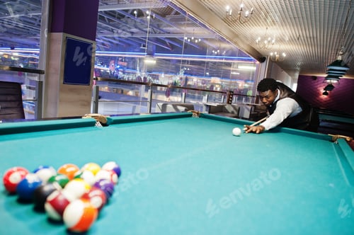 Man Plays Billiards in an Urban Billiards Hall