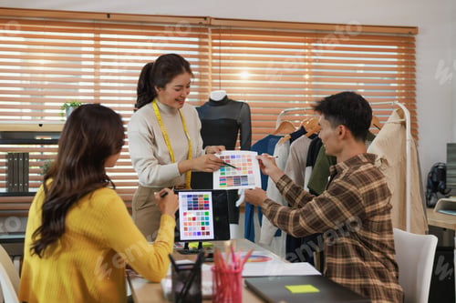 Preview: Fashion designers collaborating on color palette for clothing collection