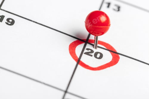 Preview: Marking an important date on the calendar with a red pin on the twentieth day