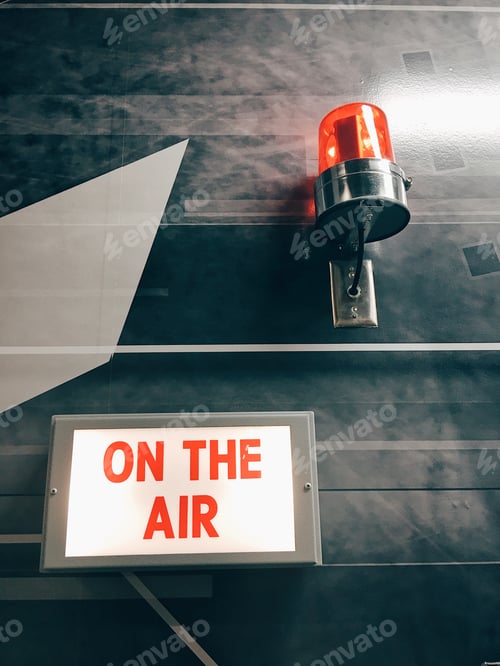Preview: "On The Air" sign inside a television studio.