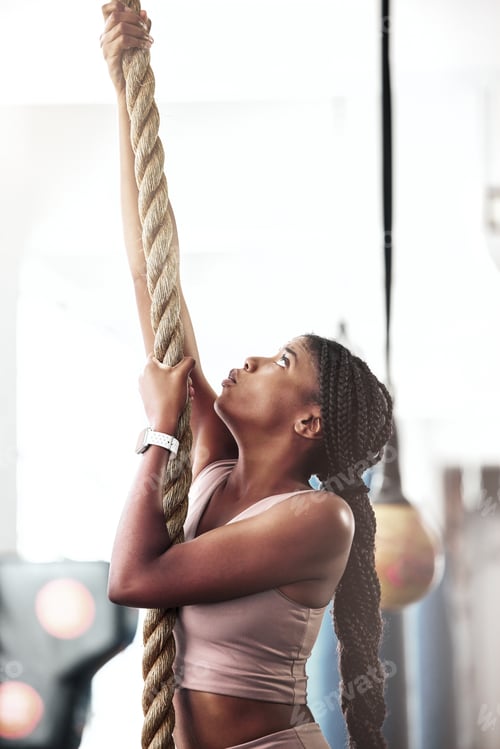 Preview: Black woman, fitness and rope climbing at gym for cross workout training for strength, energy and f