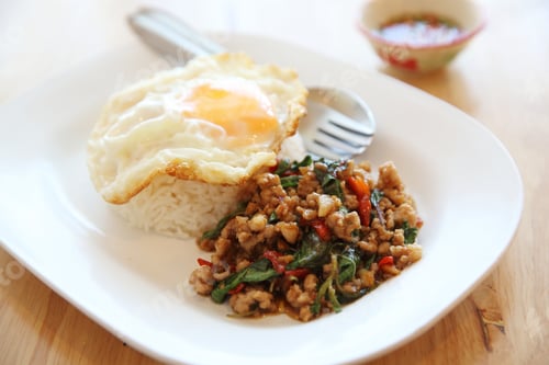 Preview: Stir Fried Pork And Basil With Rice And Egg On Wood Background Thai Food