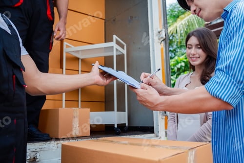 Preview: Asian Couple check while unloading boxes and furniture from a pickup truck