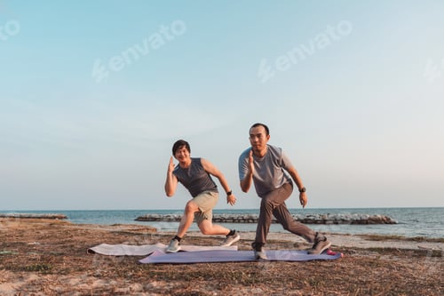 Preview: Men doing exercise together and sporty active outside sea beach training active lifestyle.