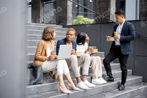 Preview: Business team talking, eating and drinking coffee
