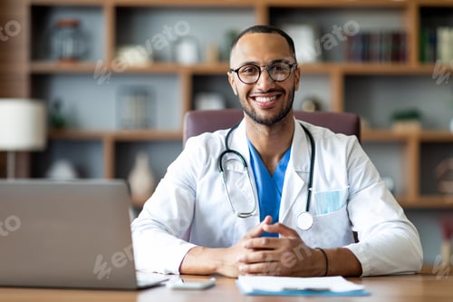 Preview: Portrait of happy arabic doctor posing at clinic