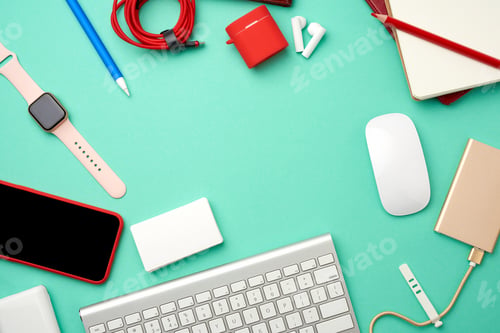 Preview: Keyboard, golden power bank with cable, red smartphone with blank black screen, headphones