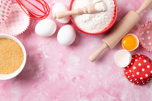 Preview: Baking background. Frame of food ingredients for baking flour, eggs, sugar on pink