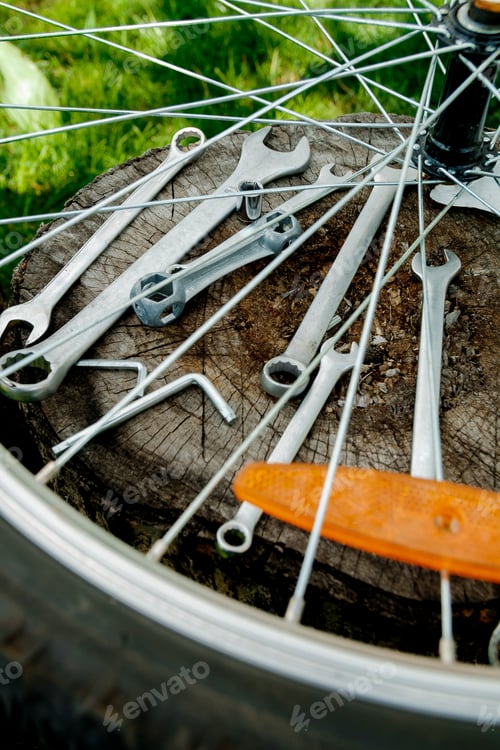 Preview: Tools, instrument for repairing bike on the wooden background outdoor wheel. Bicycle repair.