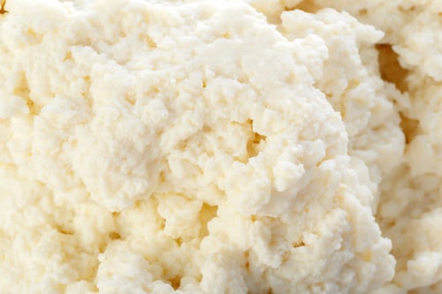 Preview: Freshly made cottage cheese in a close-up view showing its creamy texture and color