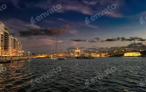 Preview: Beautiful sunset at Sliema embankment, Malta with the view on light city