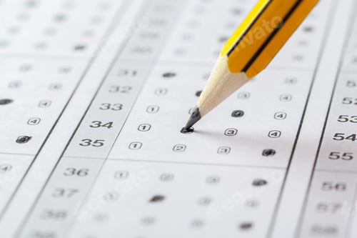 Preview: Student marks answers on an exam sheet with a pencil in a classroom setting
