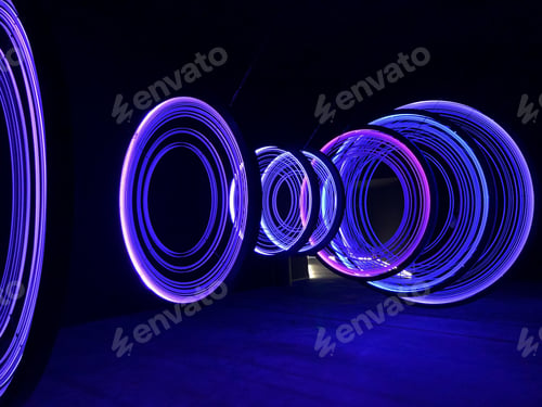 Preview: Colorful light circles in a dark room.