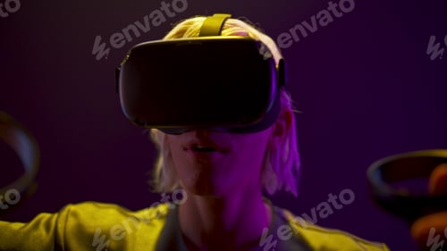 Preview: Surprised gamer playing videogame neon light. Man travelling invisible vr world