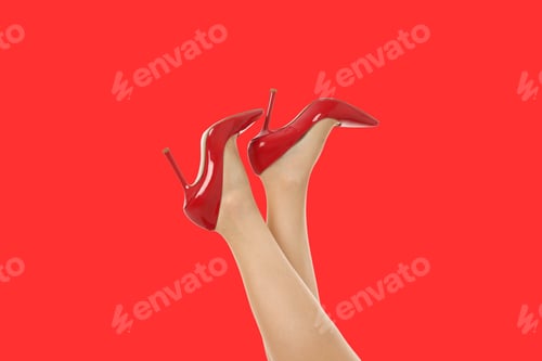 Preview: A young woman displays her legs and red high-heeled shoes