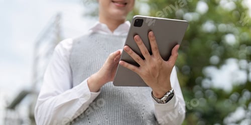 Preview: Business Professional Using Tablet Outdoors for Modern Work Solutions and Digital Communication
