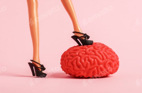 Preview: Female feet trample the human brain model on a pink background. Hack the brain concept.