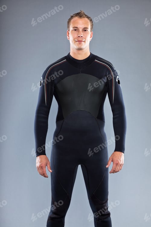 Preview: Serious Confident Man With Short Hair Wearing Wetsuit. Kite Surfer. Studio Shot. Isolated On Grey