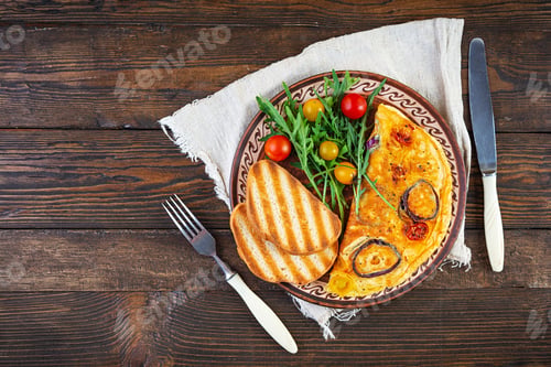 Preview: Omelet with tomato, onion, cheese and herbs. Tasty breakfast omelette. Top view