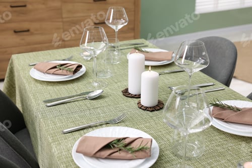 Preview: Stylish table setting with olive tablecloth, glasses and candles indoors