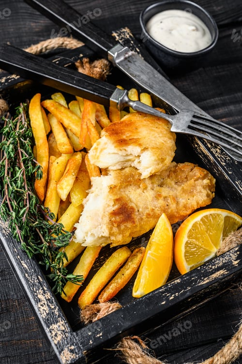 Preview: Battered Fish and chips dish with french fries and tartar sauce in a wooden tray.