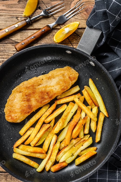 Preview: English Traditional Fish and chips dish in a pan. Wooden background. Top view