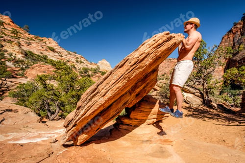 Preview: Outdoor Work Out. Man Making Pull-Ups Using Rock Formation In Zion National Park, Utah, Usa