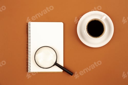 Preview: Blank notepad and coffee cup on a brown background, flat lay.