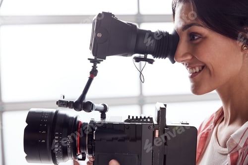 Preview: Female Videographer With Video Camera Filming Movie In White Studio