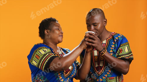 Preview: Ethnic couple enjoying aroma of fresh coffee drink