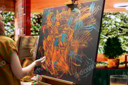 Preview: Female artist mixes pigments with her fingers to achieve the perfect hue