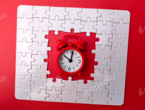 Preview: Concept red alarm clock and puzzle on red background