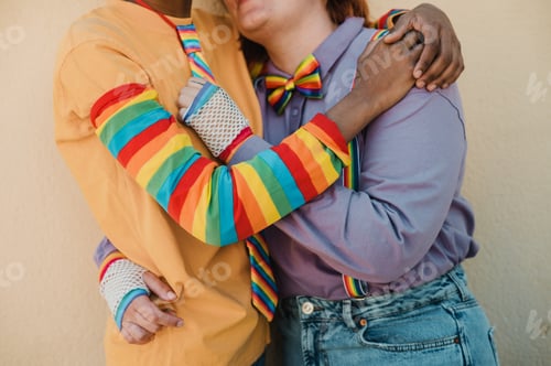 Preview: Romantic Couple Embracing Wearing Rainbow Themed Clothing