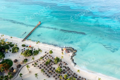 Preview: Bird's eye view of a beach with palms and a lighthouse in the Dominican Republic