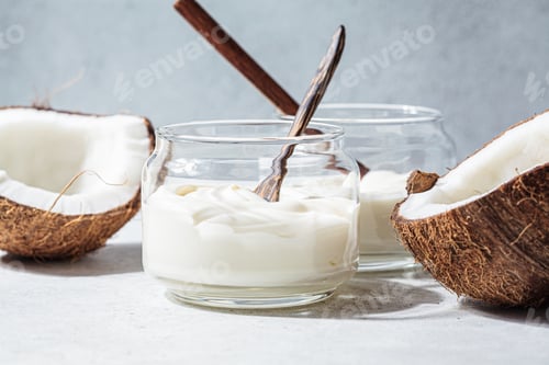 Preview: Vegan coconut yogurt in glass jars, white background. Vegan food concept.