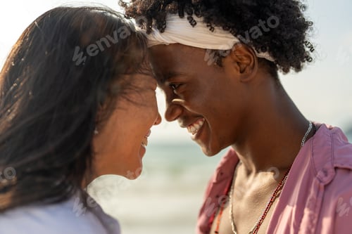 Preview: Happy couple having fun at the beach, playing and laughing together in a romantic tropical setting