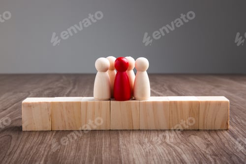 Preview: Wooden people figures on top of wooden blocks. Career growth, development and leadership