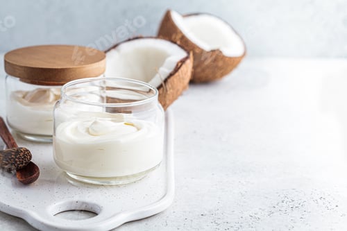 Preview: Vegan coconut yogurt in glass jars, white background. Vegan food concept.