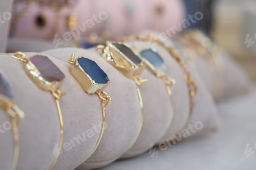 Preview: Colorful gemstone bracelets displayed at a craft market