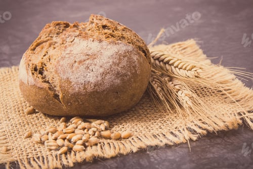 Preview: Fresh baked rolls with seeds and ears of rye or wheat grain. Vintage photo